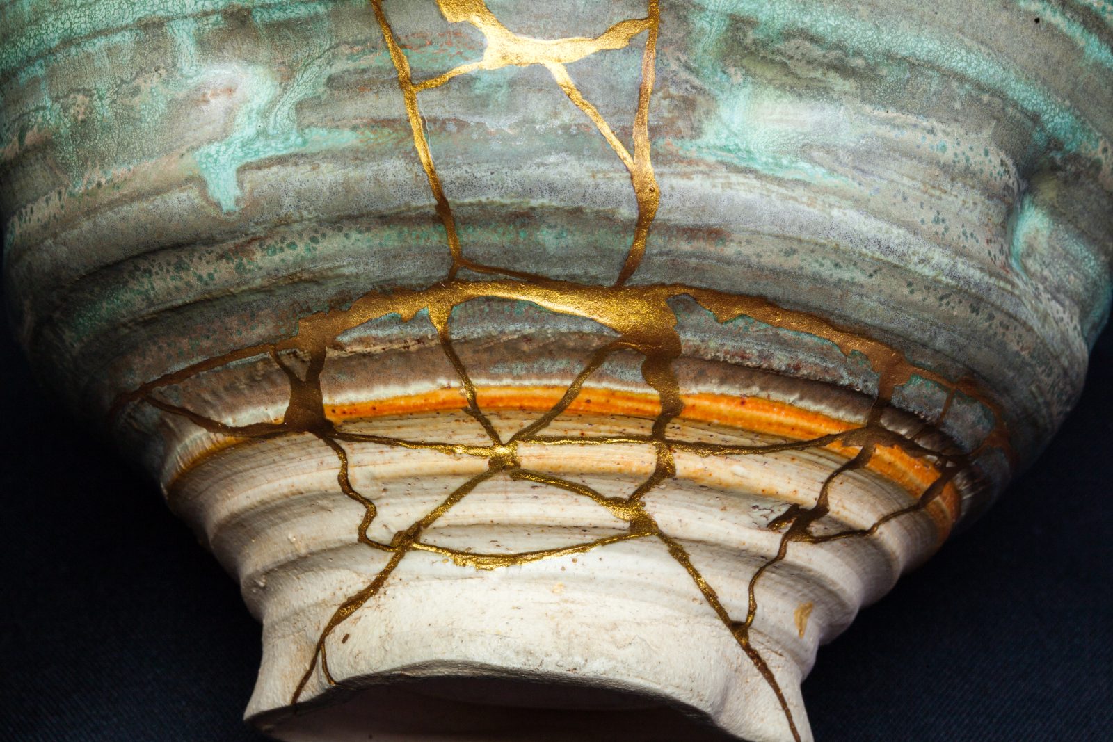 A kintsugi bowl, its cracks mended with gold
